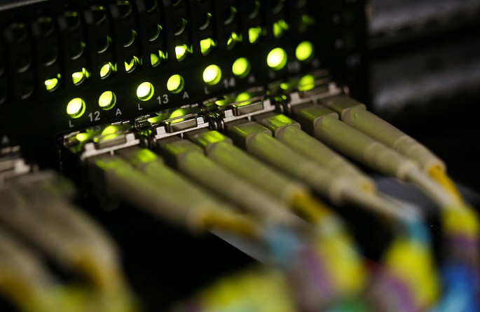 Fiber-optic cables are attached into a server inside a communications room in London.