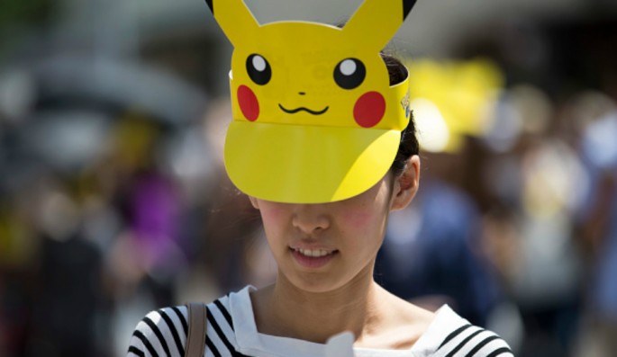 A woman wearing a Pikachu shaped sun visor arrives for the Pikachu Outbreak event hosted by The Pokemon Co. on August 7, 2016 in Yokohama, Japan. 