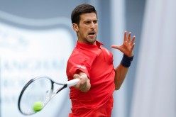 Novak Djokovic hits a tennis ball with great force as he returns it to his opponent.