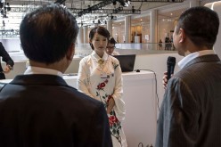 Visitors talk to Jiajia, a humanoid robot developed and created by scientists from the University of Science and Technology of China, during the World Economic Forum in June.
