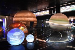 A visitor looks at displays at the Pingtang International Experience Planetarium in Guizhou Province.