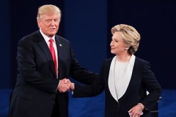 Republican presidential nominee Donald Trump shakes hands with Democratic presidential nominee former Secretary of State Hillary Clinton during the town hall debate at Washington University on October 9, 2016 in St Louis, Missouri. 