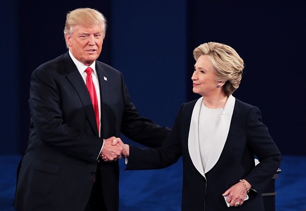 Republican presidential nominee Donald Trump shakes hands with Democratic presidential nominee former Secretary of State Hillary Clinton during the town hall debate at Washington University on October 9, 2016 in St Louis, Missouri. 