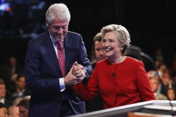 Democratic presidential nominee Hillary Clinton shakes hands with husband and former U.S. President Bill Clinton after the second 2016 Presidential Debate at Hofstra University in Hempstead, New York.