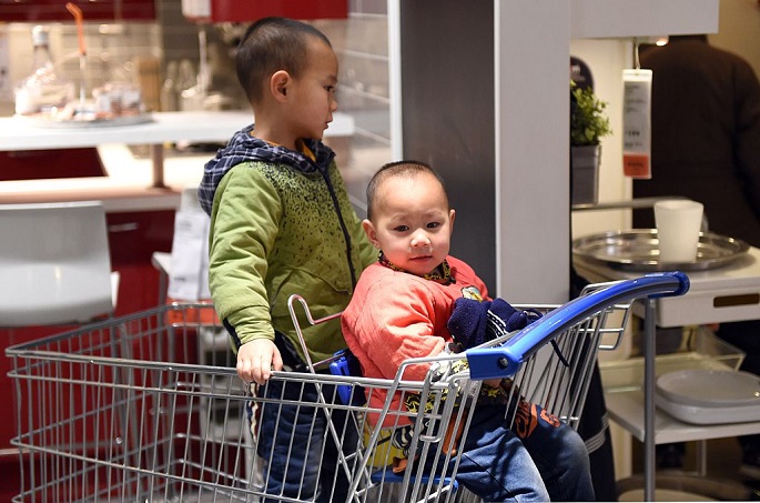 Don’t worry I've got your back: Two boys keep each other company at a furniture store in Beijing, on Jan. 19, 2015.
