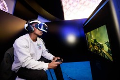 A man plays a game using a Playstation VR headset developed by Sony Interactive Entertainment LLC.