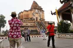 Chinese tourists have their photos taken at Wat Chedi Luang in Chiang Mai, Thailand.