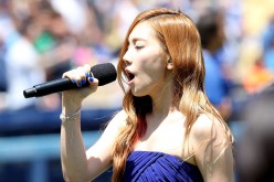 Taeyeon of Korean Pop group Girls Generation sings the Korean national anthen during Korea Day ceremonies before the game between the Cincinnati Reds and the Los Angeles Dodgers at Dodger Stadium on July 28, 2013 in Los Angeles, California. 