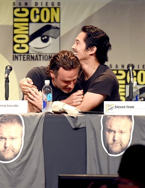 Andrew Lincoln and Steven Yeun embrace onstage at AMC's 'The Walking Dead' panel during Comic-Con International 2015 at the San Diego Convention Center on July 10, 2015 in San Diego, California. 