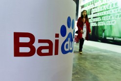 A woman walks toward a booth owned by Baidu at the China (Shanghai) International Technology Fair in Shanghai in April.