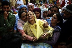 Relatives of a Kashmiri man mourn his violent death.    