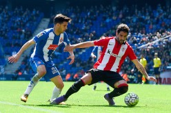 Athletic Bilbao midfielder Raul Garcia (R) competes for the ball against Espanyol's Javi Lopez.