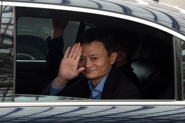 Alibaba founder and chairman Jack Ma waves as he leaves a hotel in Singapore following a meeting with investors in 2014.