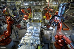 Robots work on an automobile at a Volvo production plant in Sweden.