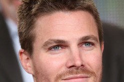 Actor Stephen Amell listens onstage to the panel discussion during the 'Arrow' and 'The Flash' panel as part of The CW 2015 Winter Television Critics Association press tour at the Langham Huntington Hotel & Spa on January 11, 2015 in Pasadena, California.