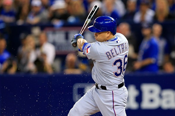Carlos Beltran of the Texas Rangers hits an RBI against the Toronto Blue Jays in the first inning during Game Three of the  2016 ALDS.