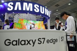 Visitors experience Samsung Galaxy S7 and S7 Edge devices during the Korea Electronics Grand Fair at an exhibition hall in Seoul on October 27, 2016.
