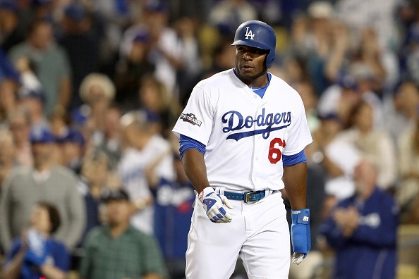 Yasiel Puig celebrates after he scores in the eighth inning of Game 3 of the ALCS on a double by Joc Pederson.