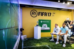 Ajax Amsterdam players Koen Weijland (L) and Jairo Riedewald play a game on an 'Xbox One' during the opening of the FIFA 17 Xperience in Amsterdam on September 22, 2016. 