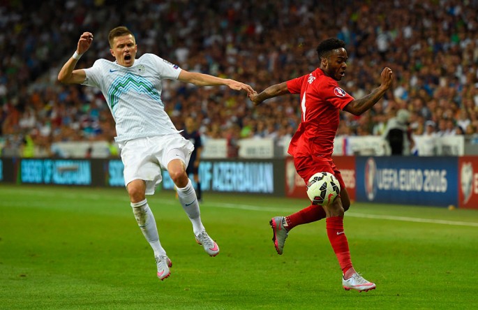 Slovenia midfielder Josip Ilicic (L) competes for the ball against England's Raheem Sterling.