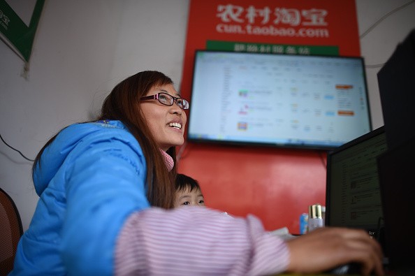A villager uses the Internet to sell products from her farm in Songtao Miao Autonomous County of Tongren in Guizhou Province.