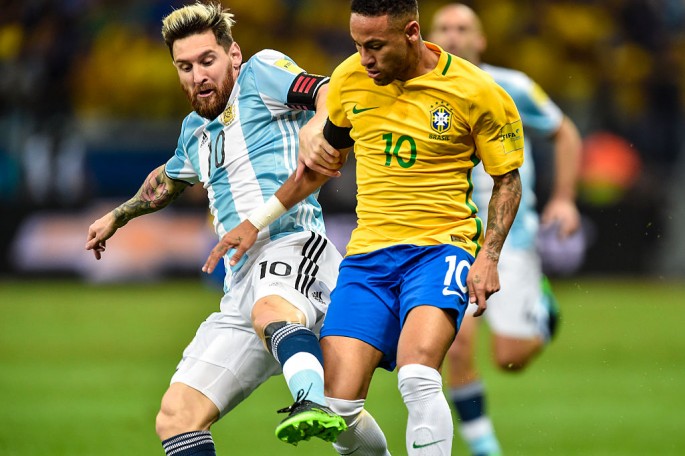 Brazil winger Neymar (R) competes for the ball against Argentina's Lionel Messi.