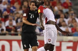 Trinidad and Tobago striker Kenwyne Jones (R) competes for the ball against Team USA's Steve Birnbaum.