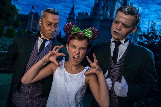 Netflix's 'Stranger Things' star Millie Bobby Brown, known as 'Eleven,' a girl with super powers against evil forces, poses with two 'grave diggers' at Magic Kingdom Park 6 in Lake Buena Vista, Florid