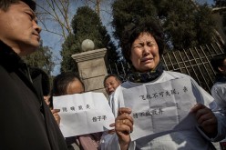 A Chinese relative of a missing passenger on Malaysia Airlines flight MH370 cries at a protest outside the Malaysia Embassy on March 8, 2015 in Beijing, China.