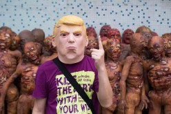 A man wears a Trump mask made in a factory in Shenzhen. 