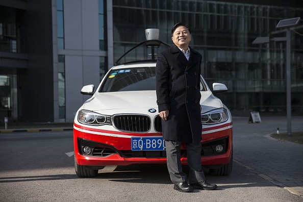 Wang Jing, Baidu's senior vice president, poses with one of the company's autonomous cars at Baidu's headquarters in Beijing.