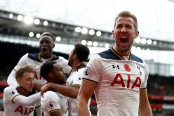 Tottenham Hotspur striker Harry Kane (R) shouts as his teammates celebrate his goal against Arsenal.