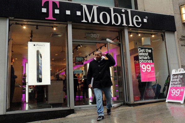 A customer walks out of a Manhattan T-Mobile store on April 12, 2013 in New York City. 
