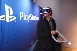 A young man trying Play Station VR at the Play Station 4 Pro