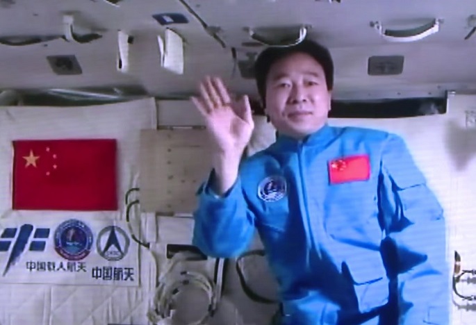 Greetings from outer space: Chinese astronaut Jing Haipeng waves as he records a video of himself delivering a message while inside the Chinese space laboratory Tiangong-2 in Oct. 2016.