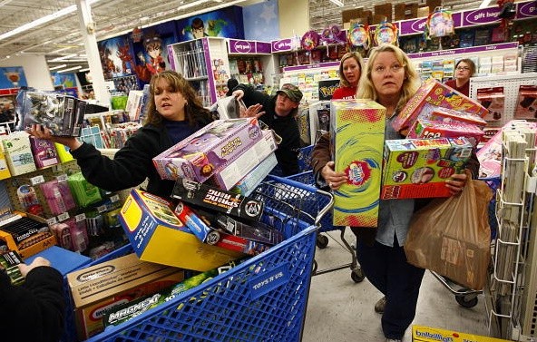 Shoppers Jeri Hull (L) and Karen Brashear (R) wait in line while shopping at Toys'R'Us during the Black Friday sales event on November 27, 2009 in Fort Worth, Texas. 