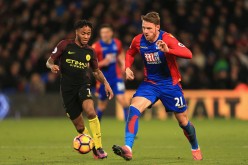 Crystal Palace winger Connor Wickham (R) competes for the ball against Manchester City's Raheem Sterling.