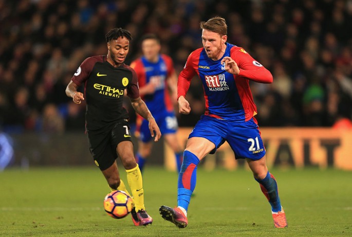 Crystal Palace winger Connor Wickham (R) competes for the ball against Manchester City's Raheem Sterling.