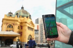 A man holds up his phone as he plays the 'Pokemon Go' game on July 13, 2016 in Melbourne, Australia. 