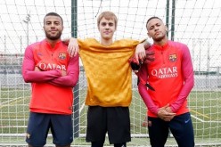 Justin Bieber poses with Neymar and Rafinha following a short training session in Barcelona.