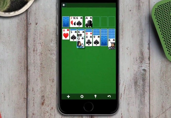 Microsoft Solitaire which was released for iOS and Android this week, being played on an iPhone.