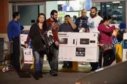 Shoppers pick up items on the eve of Thanksgiving sale