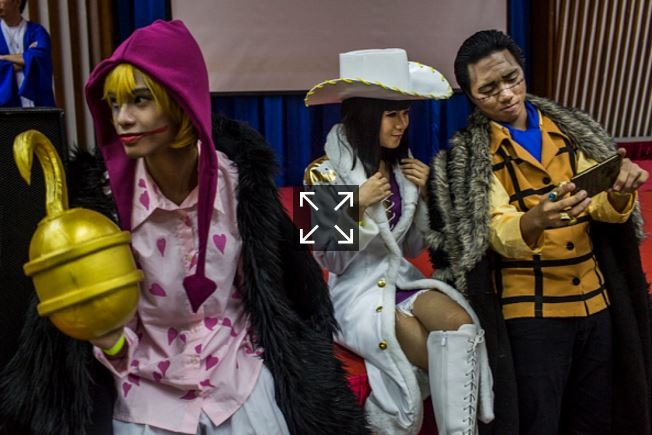 Characters from the One Piece Group take selfies on April 23, 2016 in Yangon, Burma.