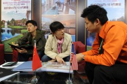 Chinese real estate investors inquire about United States property for sale at the Overseas and China Property Expo in Beijing.