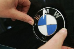 A worker fixes a BMW hood ornament onto a new BMW 3-series car on the day of the plant's offical opening on May 13, 2005 at the BMW factory in Leipzig, Germany.