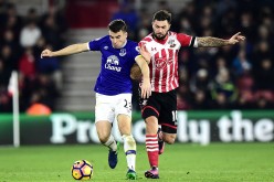 Southampton forward Charlie Austin (R) competes for the ball against Everton's Seamus Coleman.