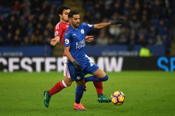 Leicester City winger Riyad Mahrez (R) competes for the ball against Middlesbrough's Fabio Da Silva.