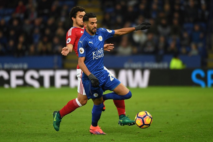 Leicester City winger Riyad Mahrez (R) competes for the ball against Middlesbrough's Fabio Da Silva.