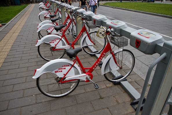 Bicycles are parked in a row at a bike-sharing station in Beijing.