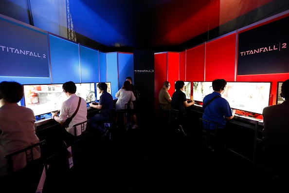 Visitors play the Titanfall 2 video game in the Konami Holdings Corp. booth at the Tokyo Game Show 2016 on September 15, 2016 in Chiba, Japan.